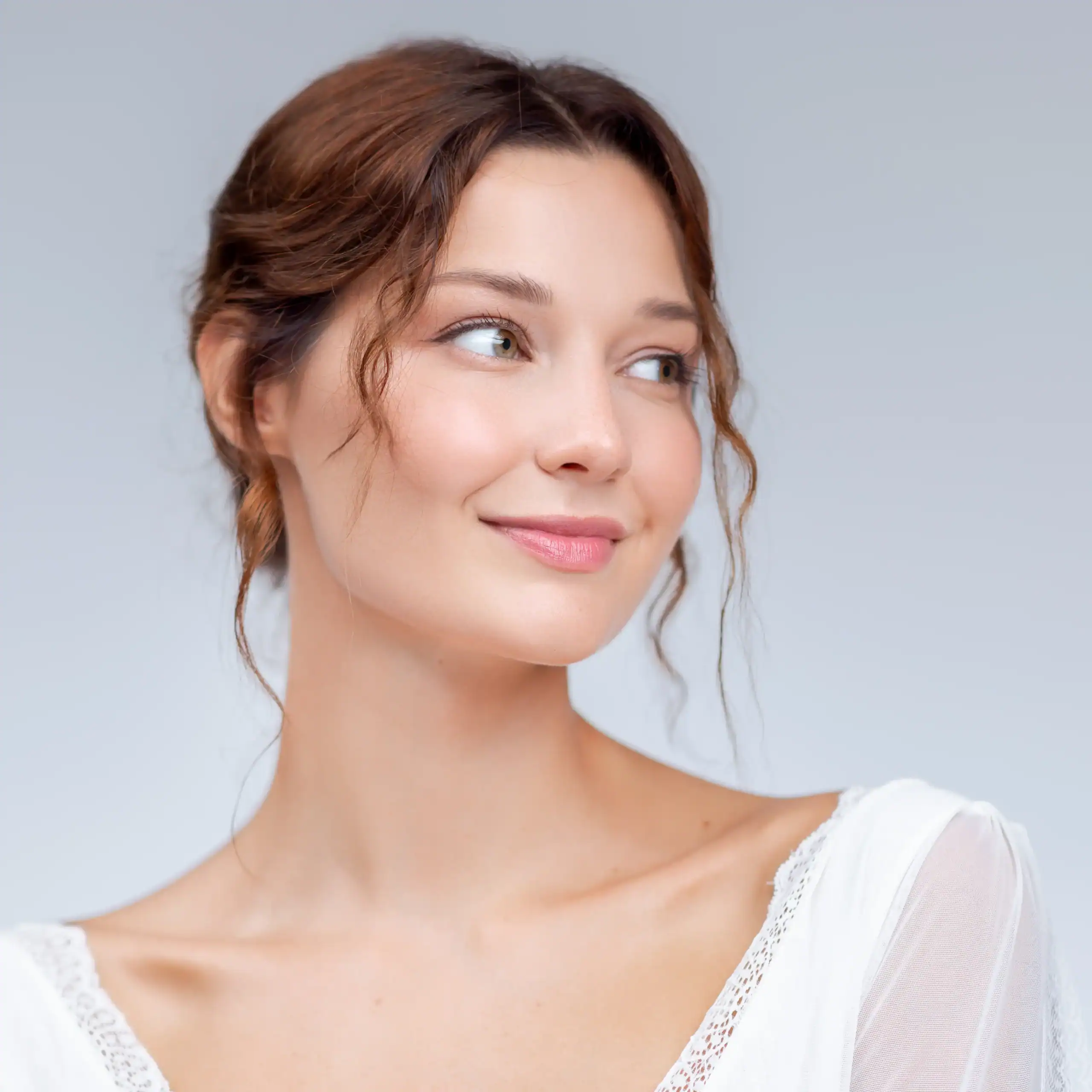 Young woman with her hair up wearing a white peasant blouse
