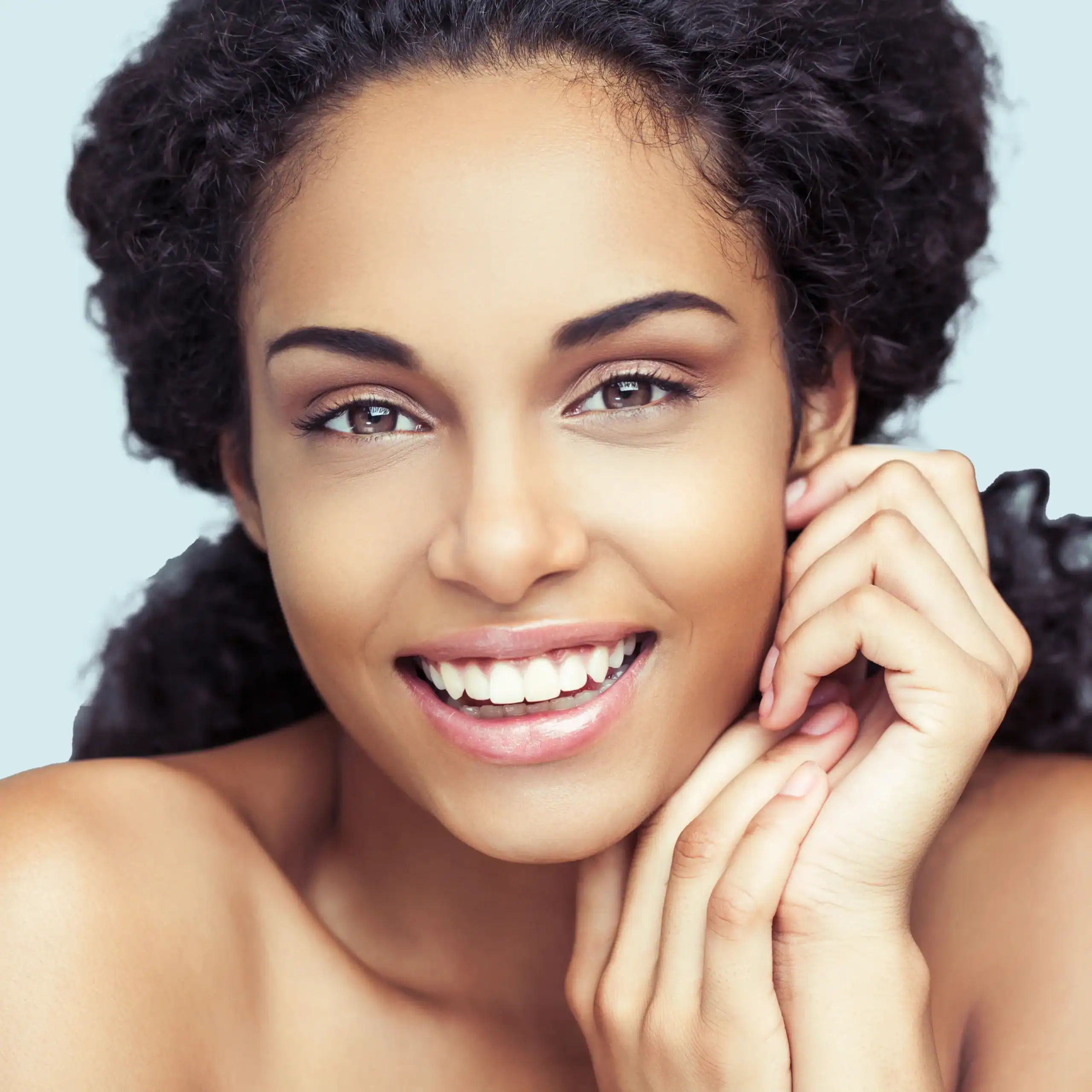 Young Black woman with beautiful skin and light brown eyes