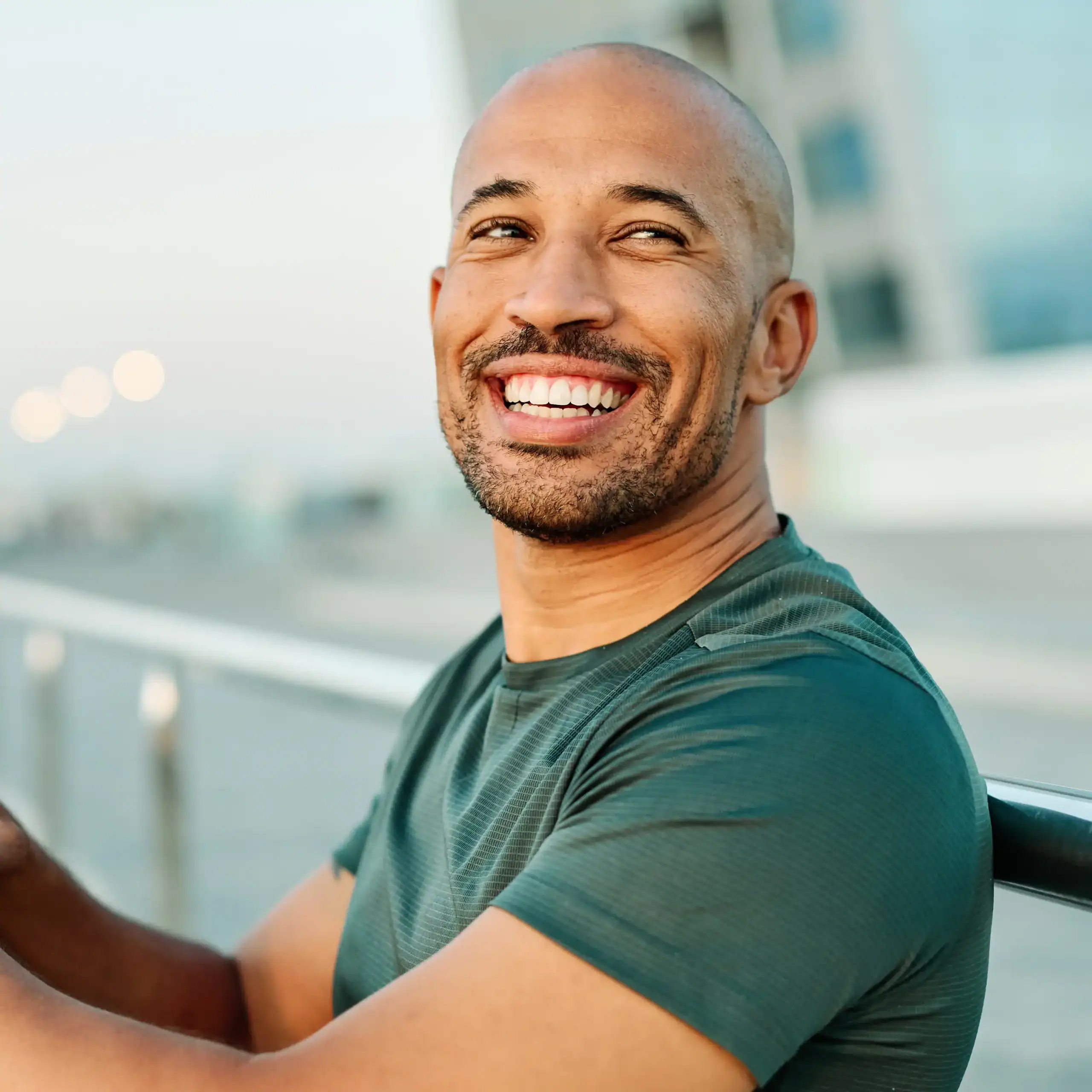 Young Black man smiles at the camera