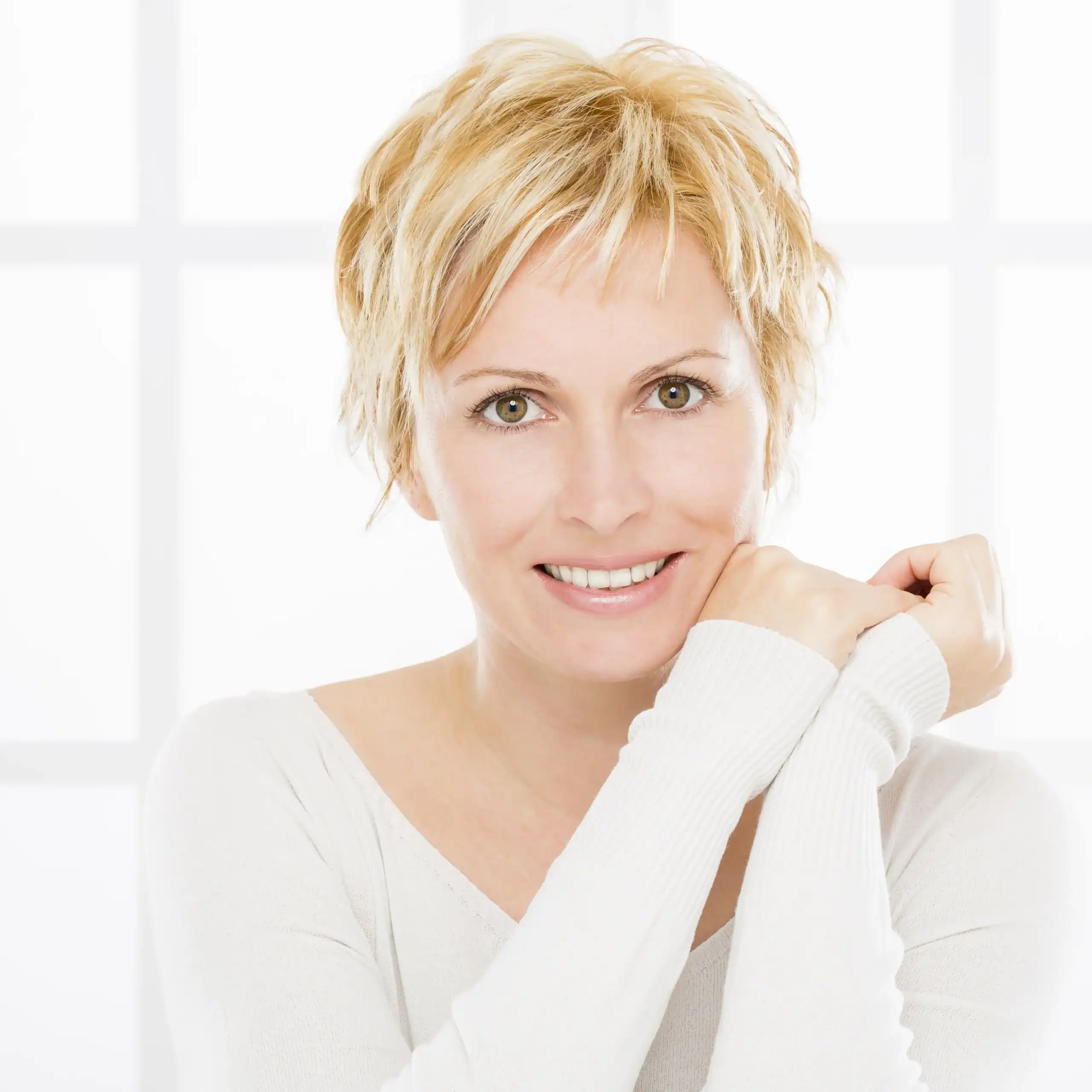 Blond woman in her 40s who looks healthy with plump skin