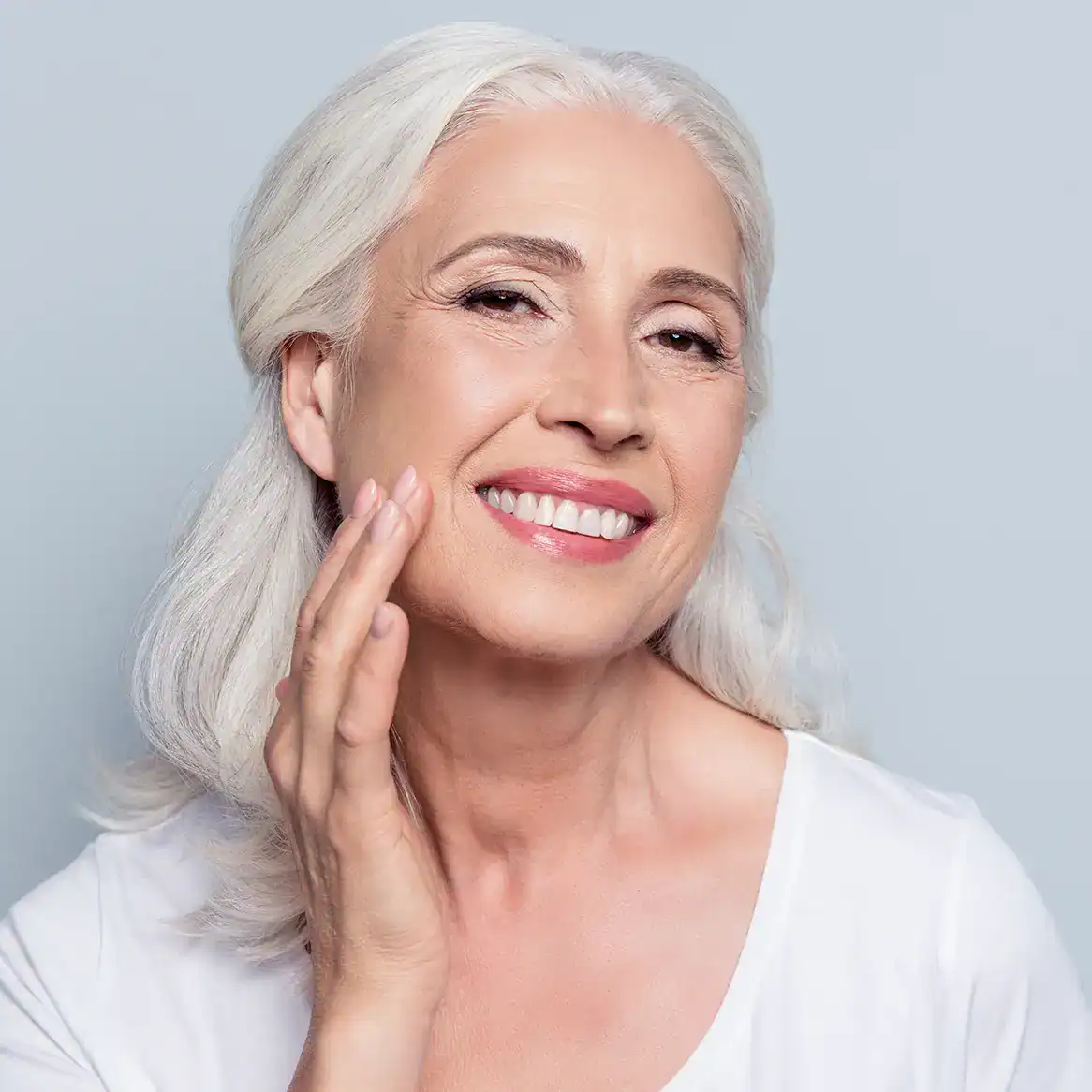 Woman with smooth skin smiling after skin rejuvenation.