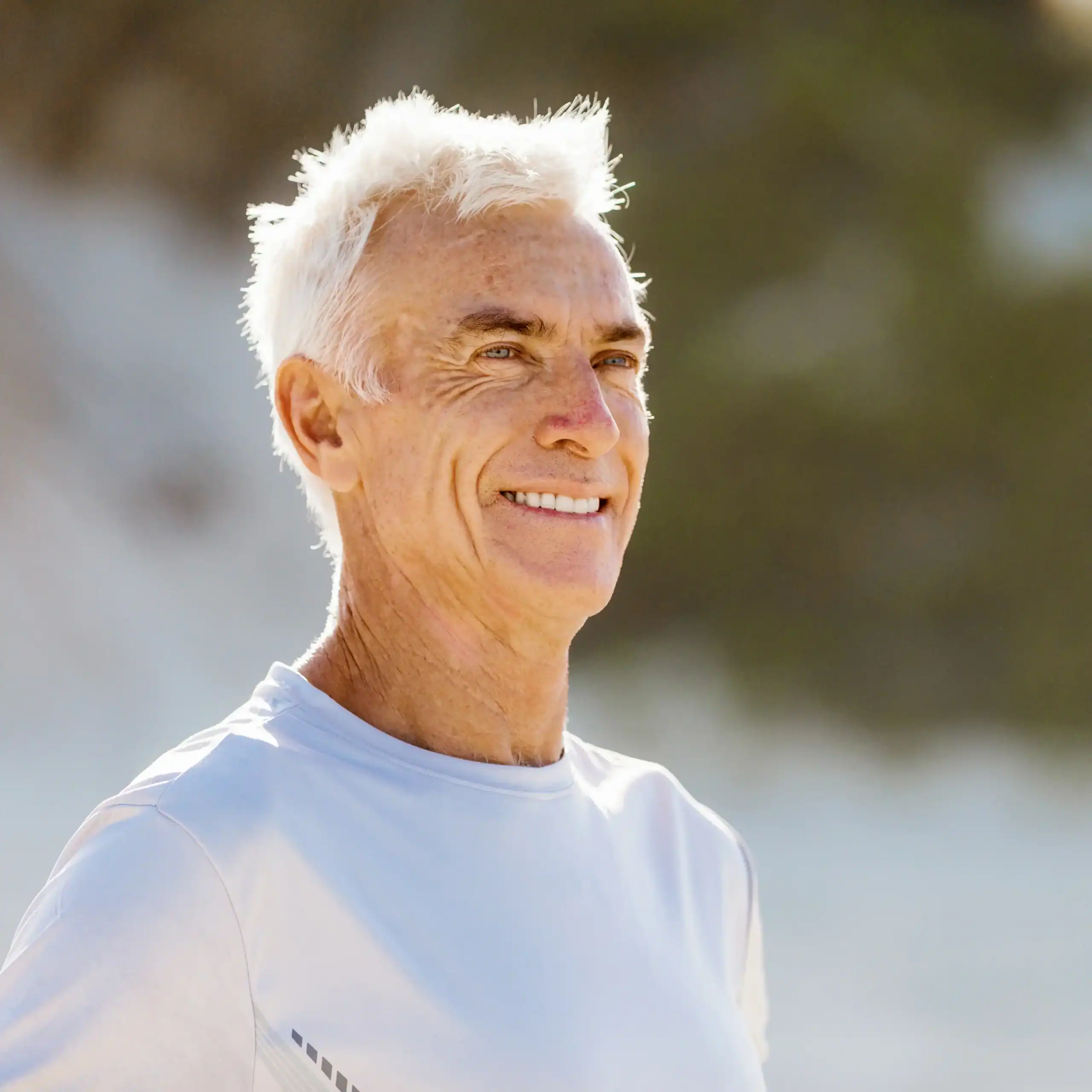 Handsome older man with white hair on the beach