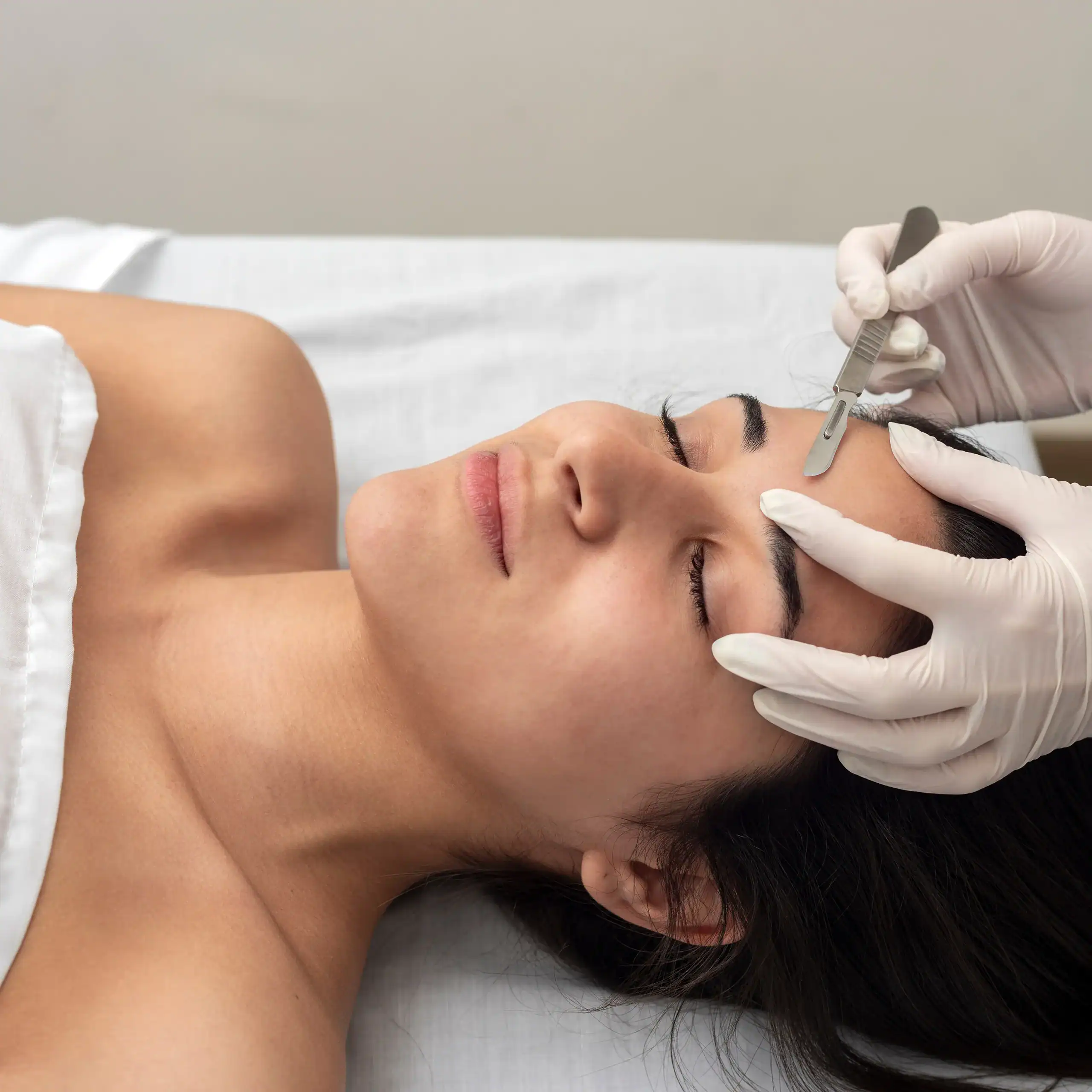Young woman receives a dermaplaning treatment.