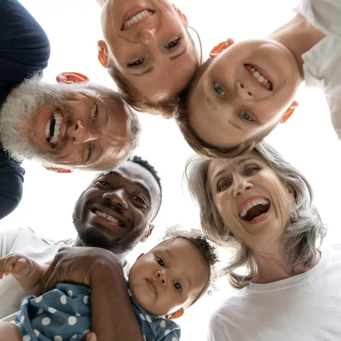 Diverse faces looking down at the camera representing diverse patients