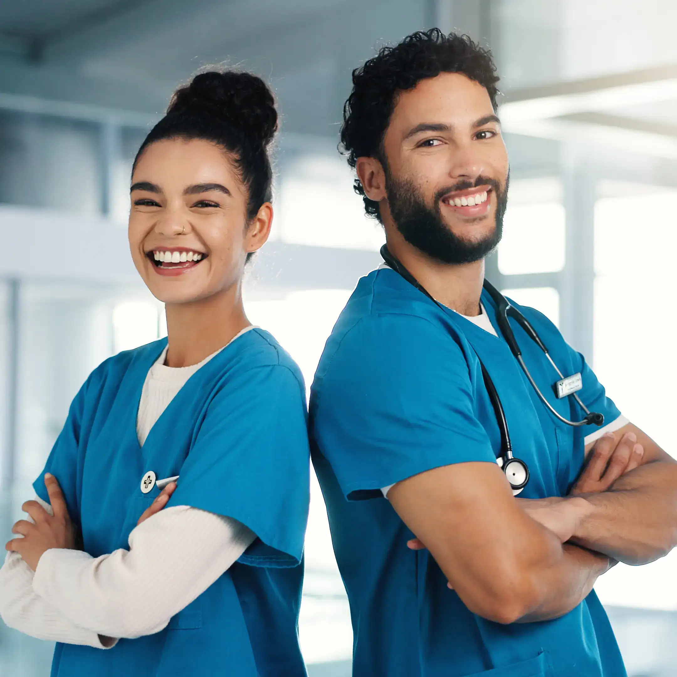 Two physician assistants standing back to back