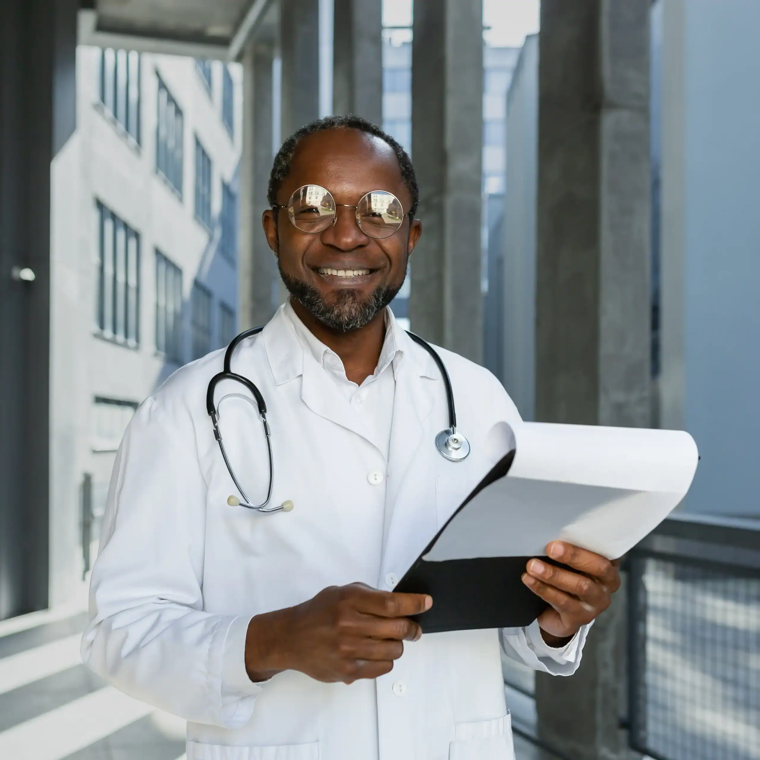 Older Black doctor holding a clipboard